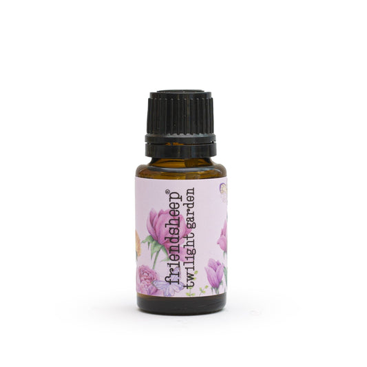 Amber glass essential oil blend bottle with ribbed black cap and floral label.