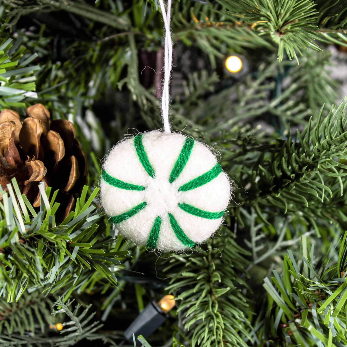 Felt peppermint swirl eco freshener ornament with white-and-green striped segments