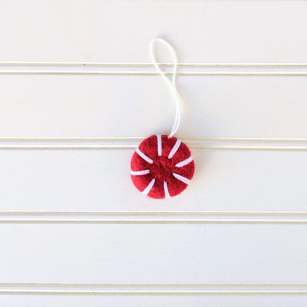 Red and white felt peppermint ornament freshener on a hanging string