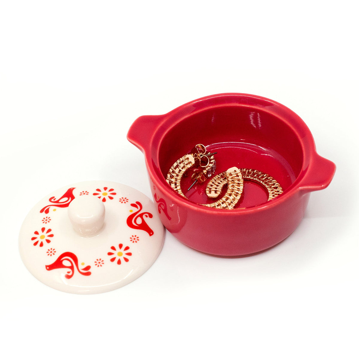 Red ceramic casserole trinket box with lid removed; gold-tone chain earrings inside.