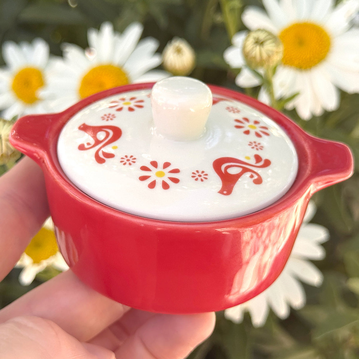 Red ceramic casserole trinket box with white lid and red decorative motifs.