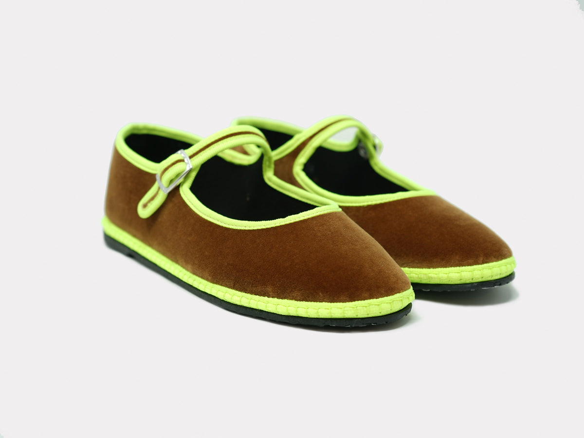 Camel suede Mary Jane flats with neon green trim and bow-style strap