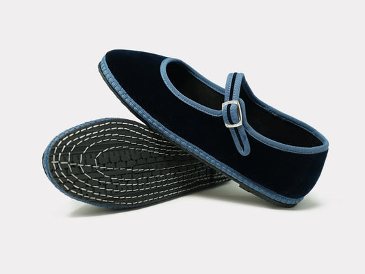 Navy Mary Jane flats with light blue strap and buckle, textured outsole