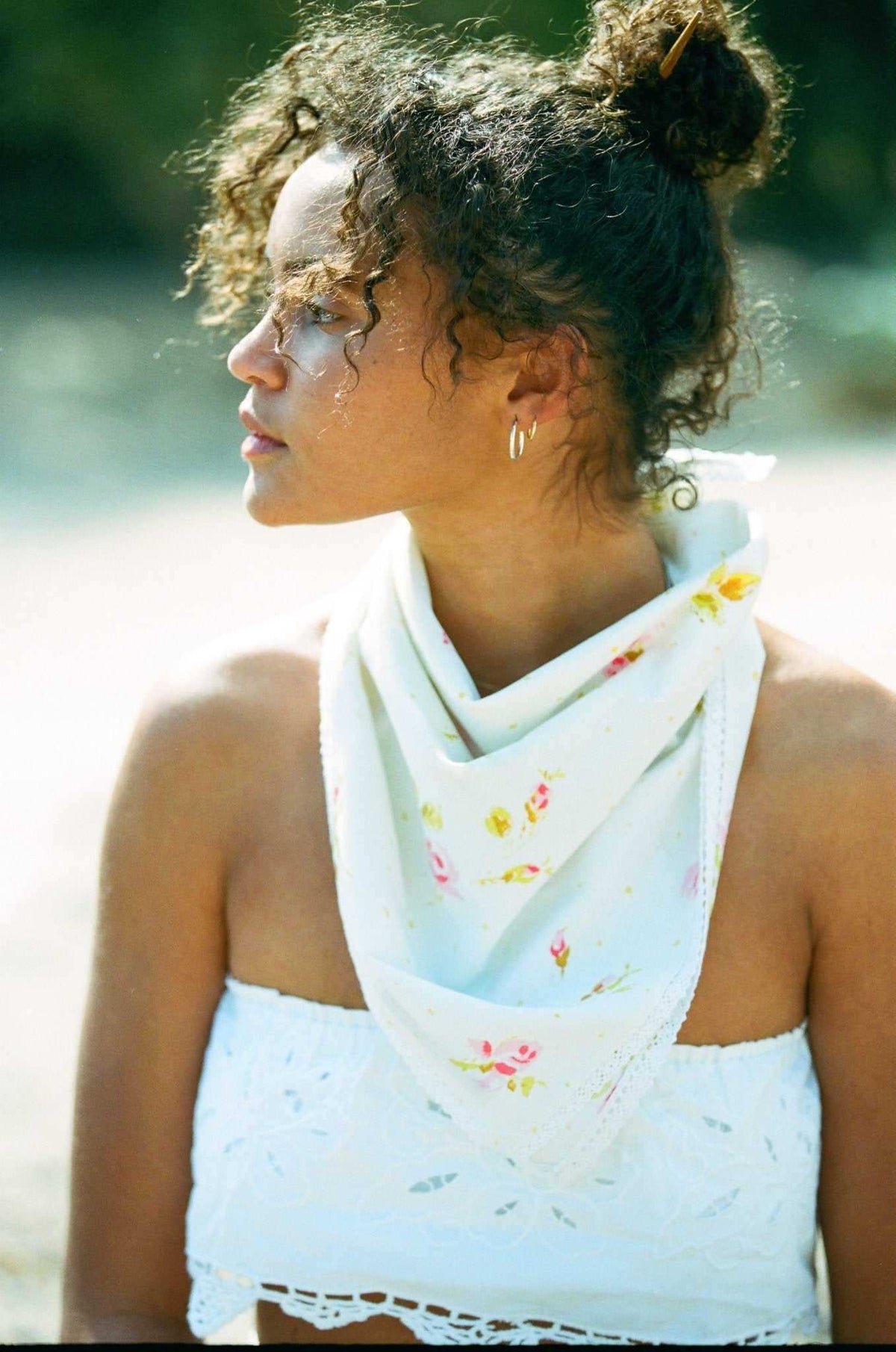 Light blue floral face bandana with small roses, worn around neck