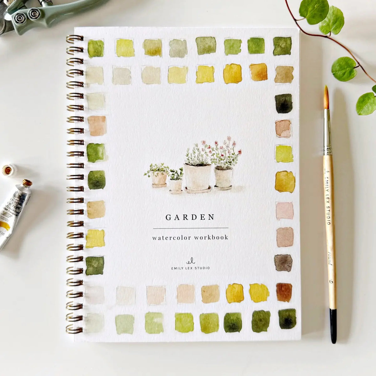 Garden watercolor workbook, spiral-bound page with garden swatches and small potted plants