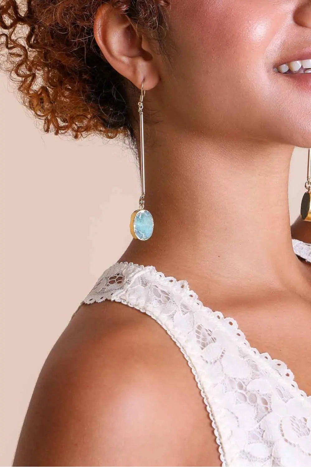 Gold-tone gemstone drop earrings with oval aqua-blue stone dangles