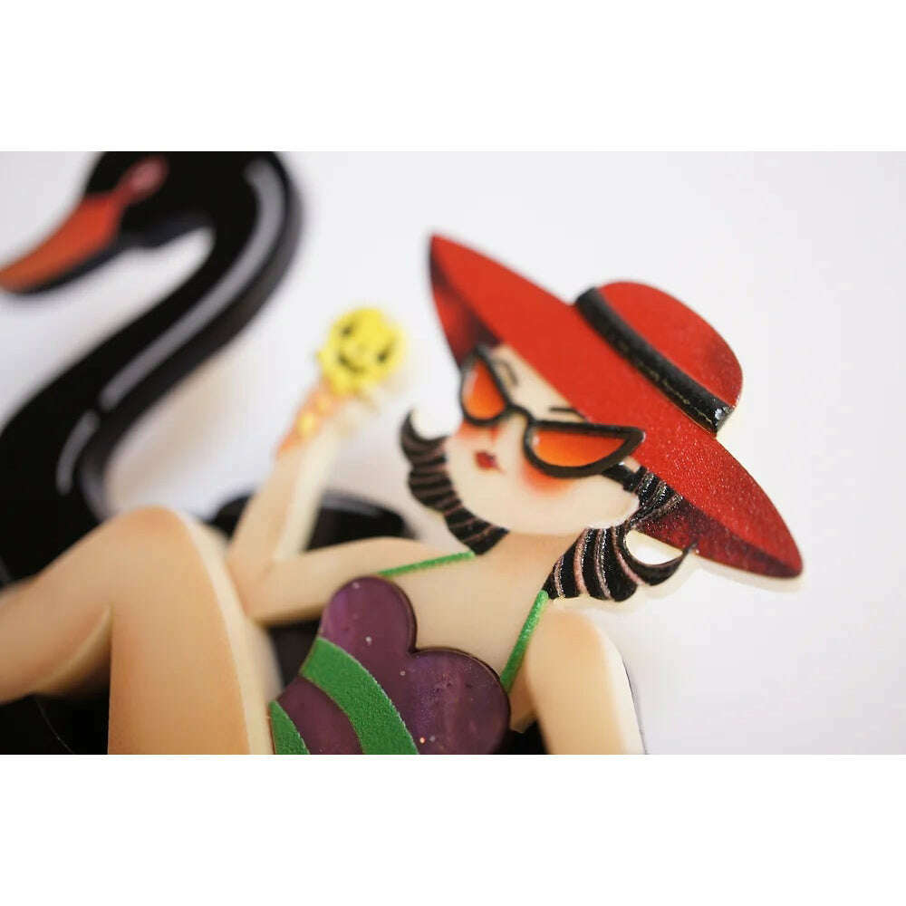 Close-up girl on swan float brooch: red hat, face details, purple dress