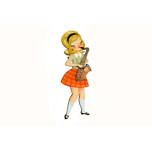 Girl playing saxophone brooch, yellow hair, green top, orange plaid skirt, gold tones.