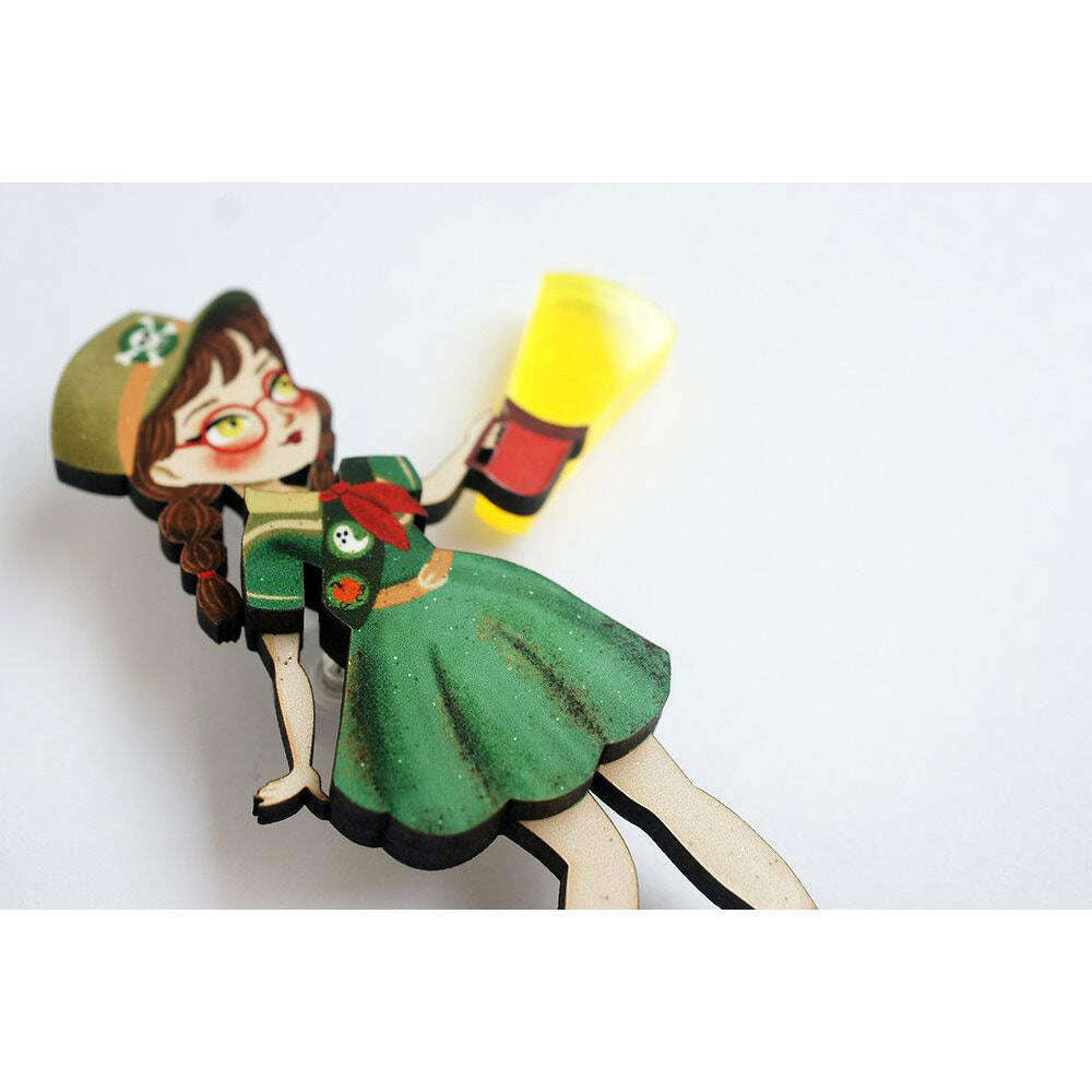 Girl Scout enamel brooch showing a cartoon scout girl waving with yellow megaphone