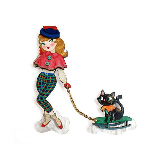 Girl and cat on sled enamel brooch with gold-tone chain detail