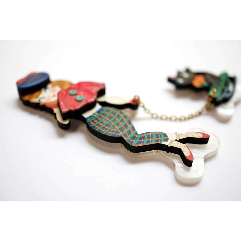 Enamel girl and cat on sled brooch viewed from the side with chain