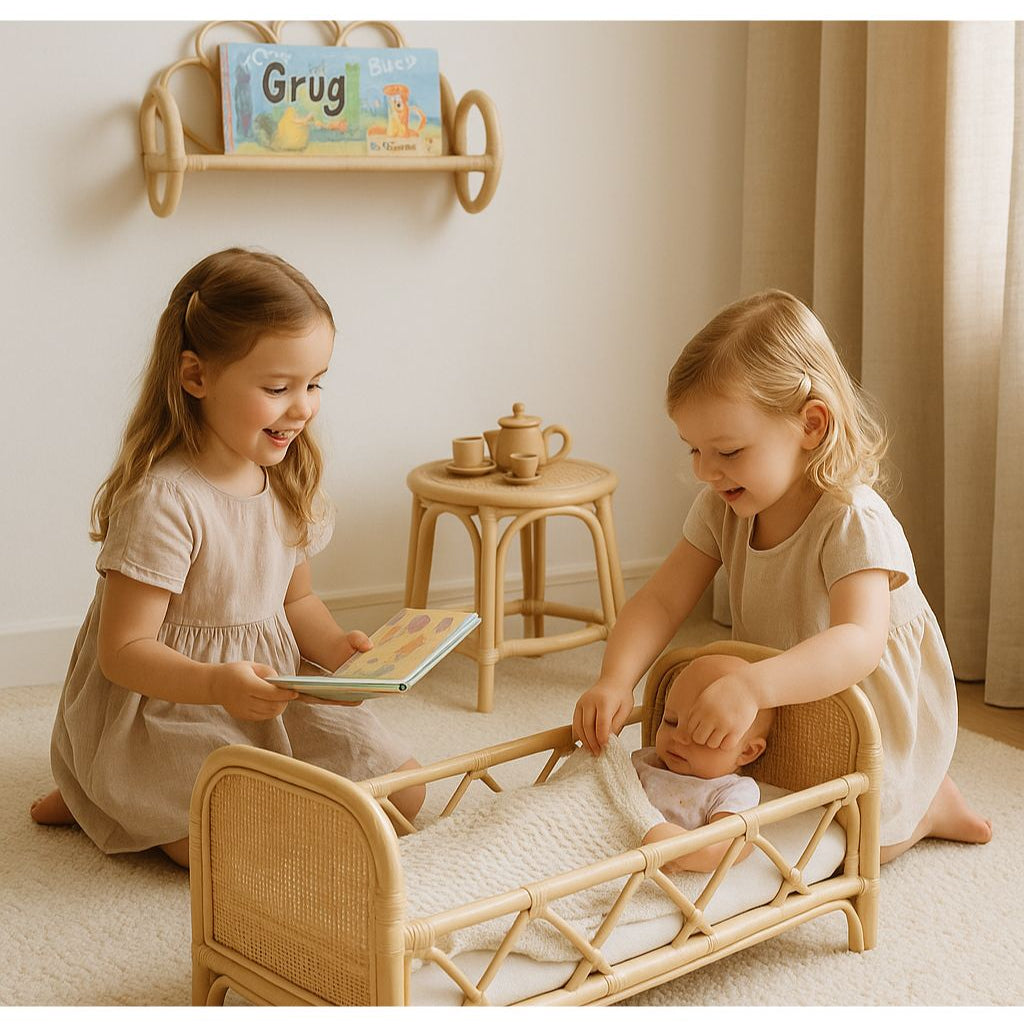 Natural rattan doll bed with a woven frame and a doll tucked under a blanket