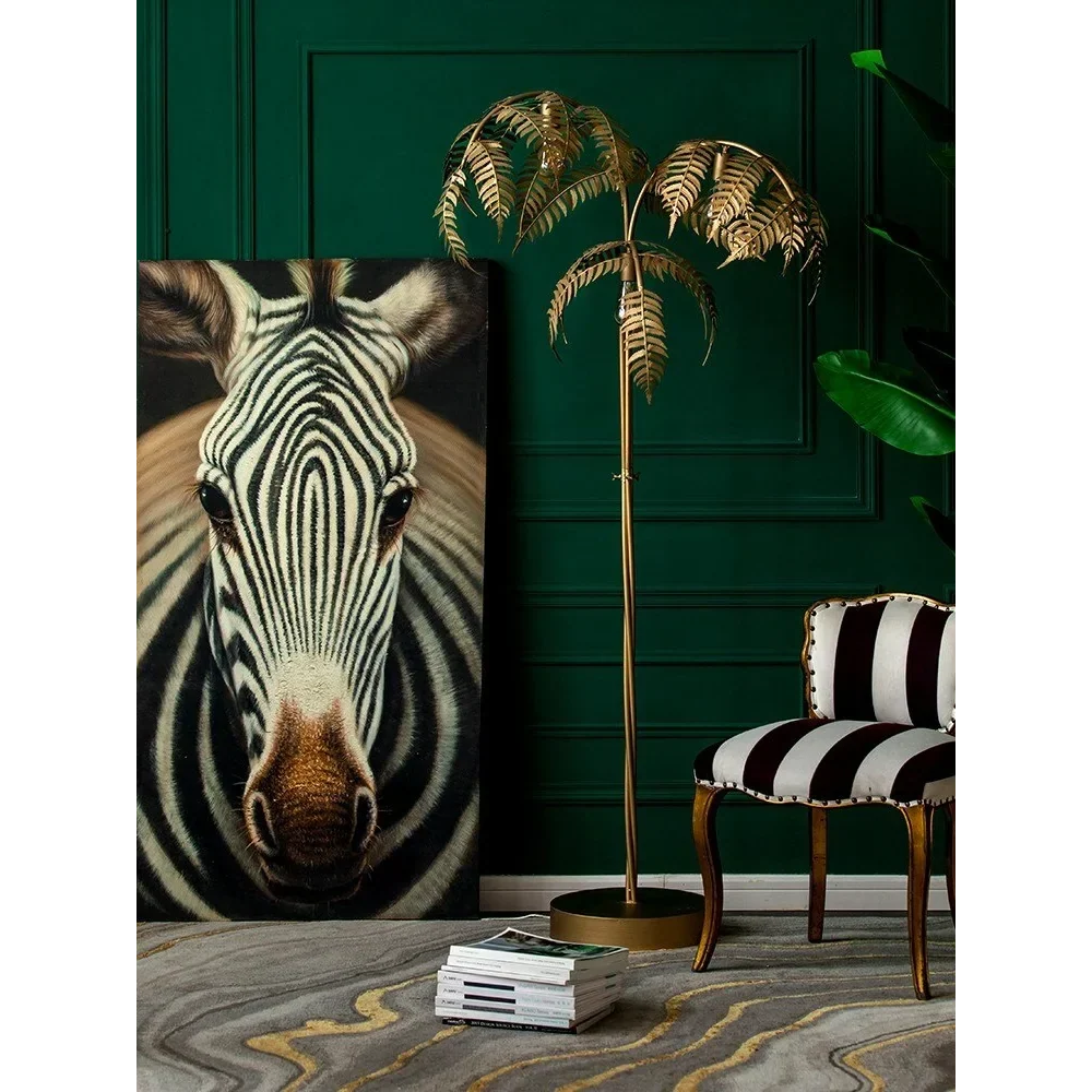 Gold palm tree floor lamp with sculptural fronds and round base