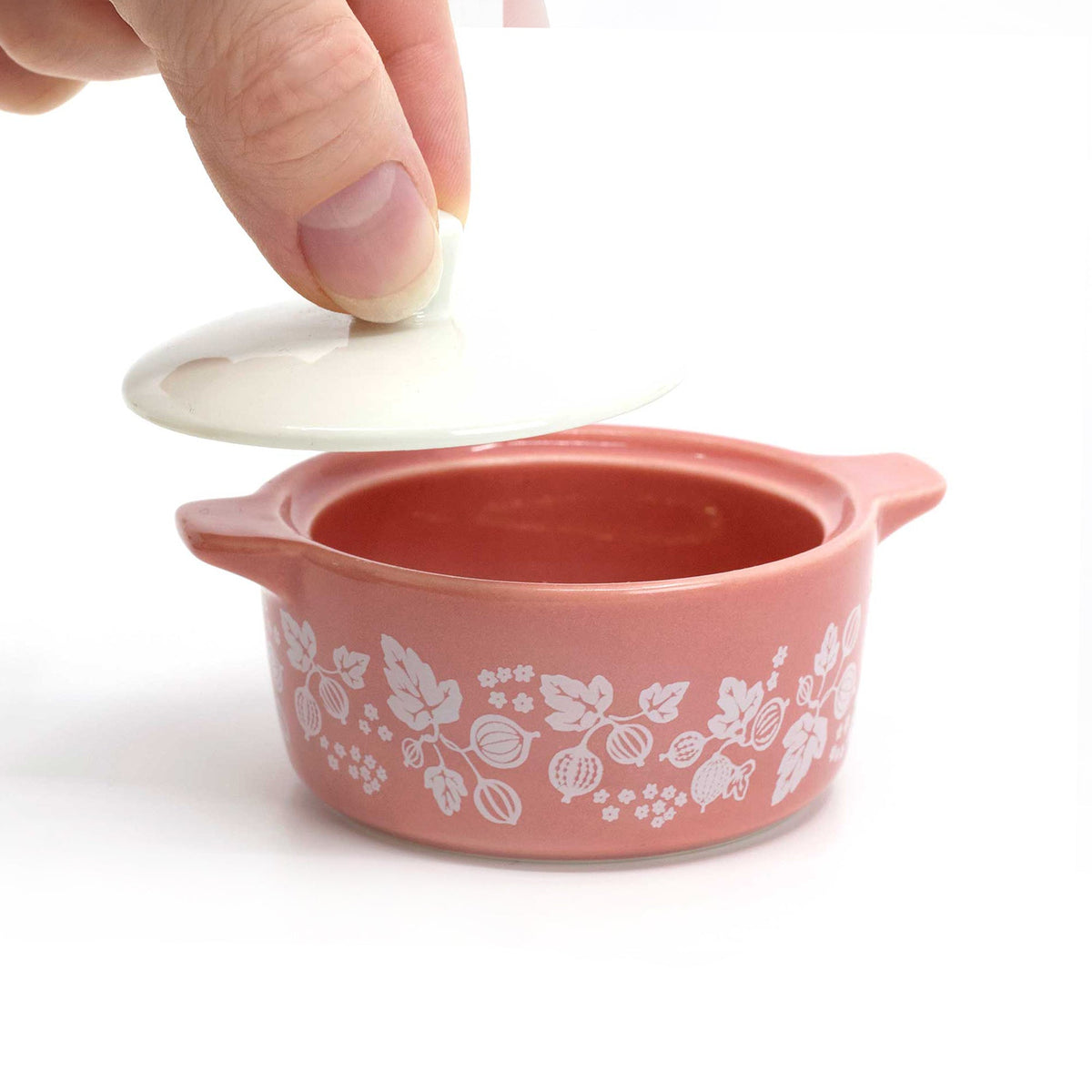 Pink ceramic casserole trinket box with floral pattern and white glaze, lid lifted