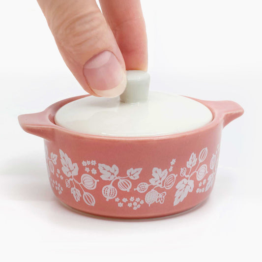 Pink ceramic casserole-style trinket box with floral pattern and white lid
