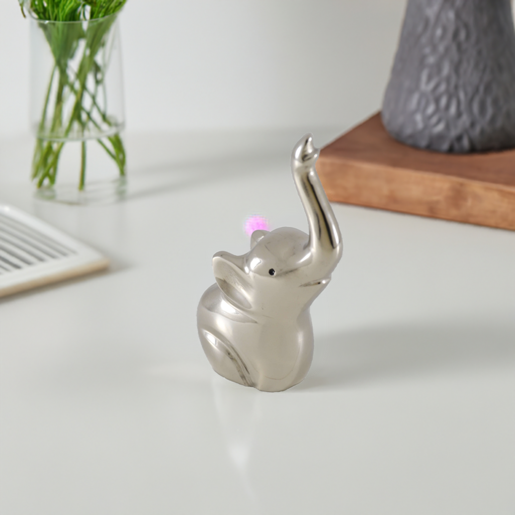Silver elephant ring holder sculpture with upright trunk holding rings