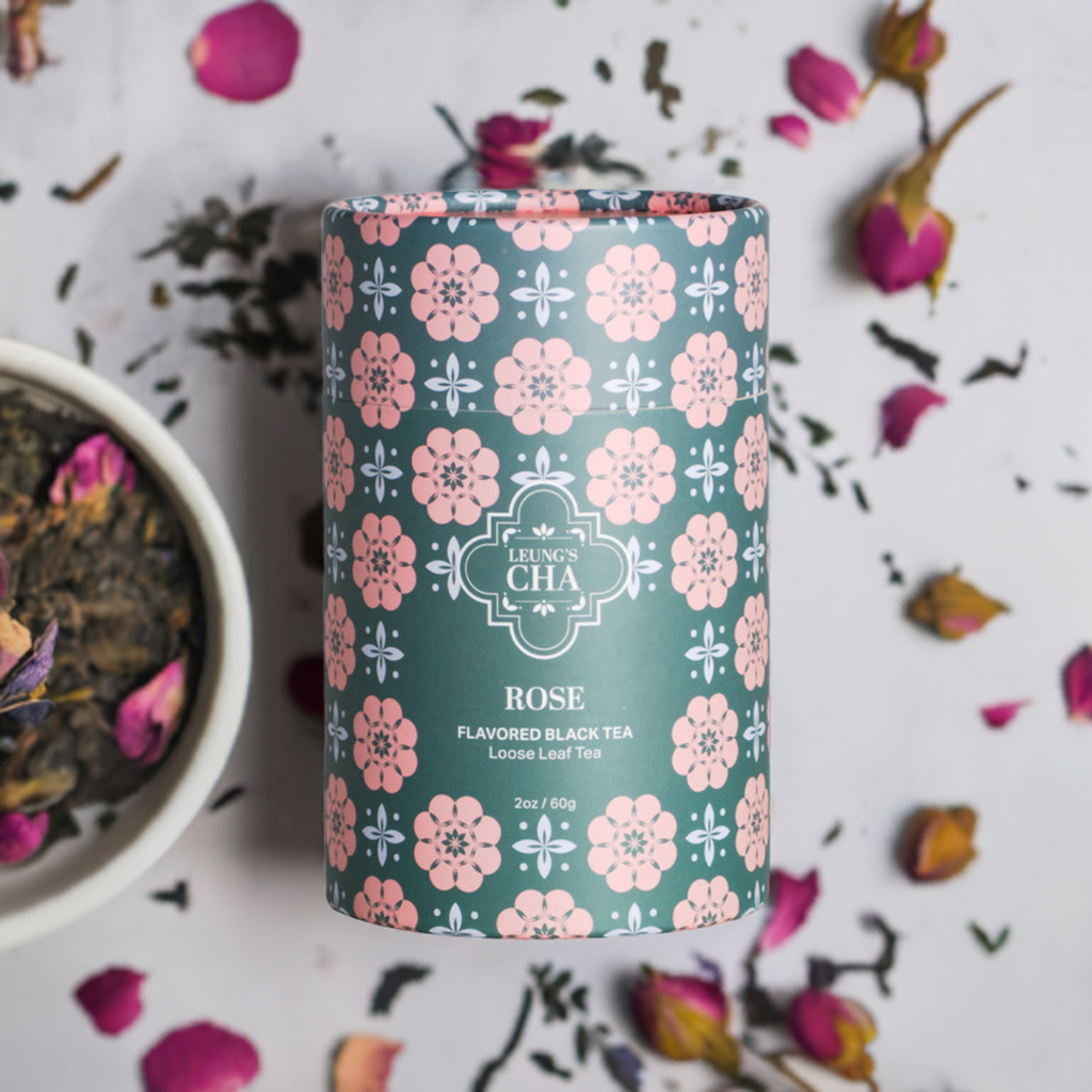 Floral rose-pattern tea tin with loose tea leaves scattered around