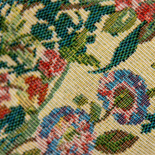 Close-up of multicolor woven bow tie pattern in green, red, and cream