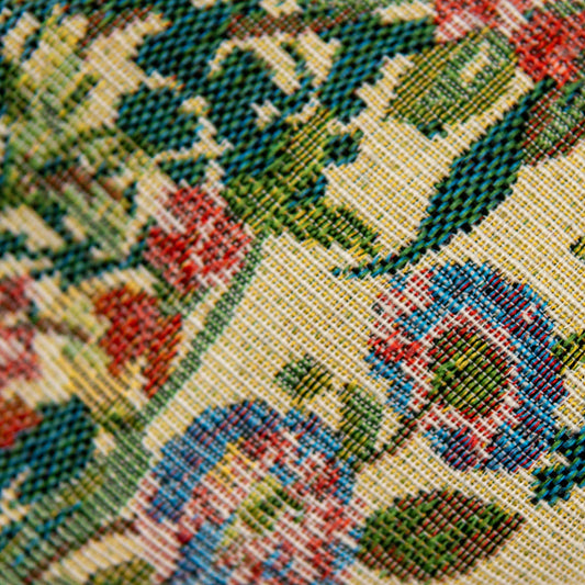 Hair sash fabric close-up with multicolor woven pattern and floral shapes.