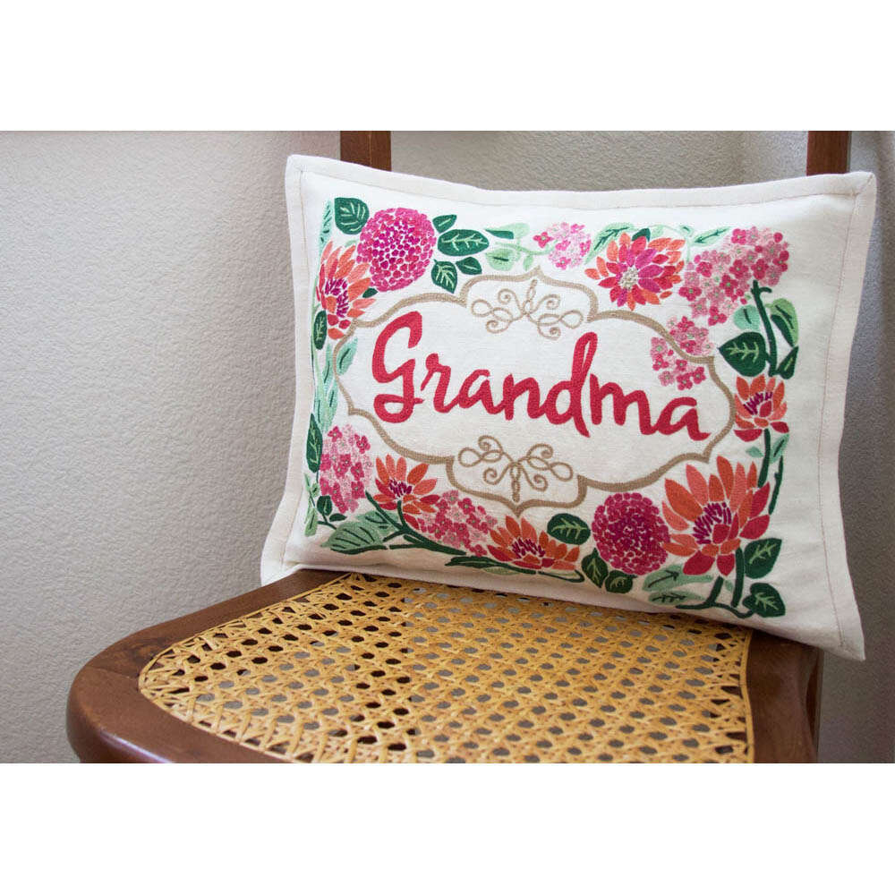 Rectangular embroidered pillow showing 'Grandma' and colorful flowers on off-white