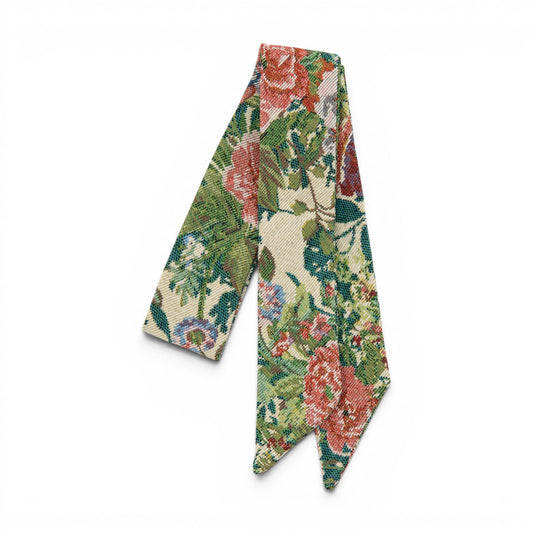Hair sash with multicolor floral patchwork pattern, folded ribbon for tying.