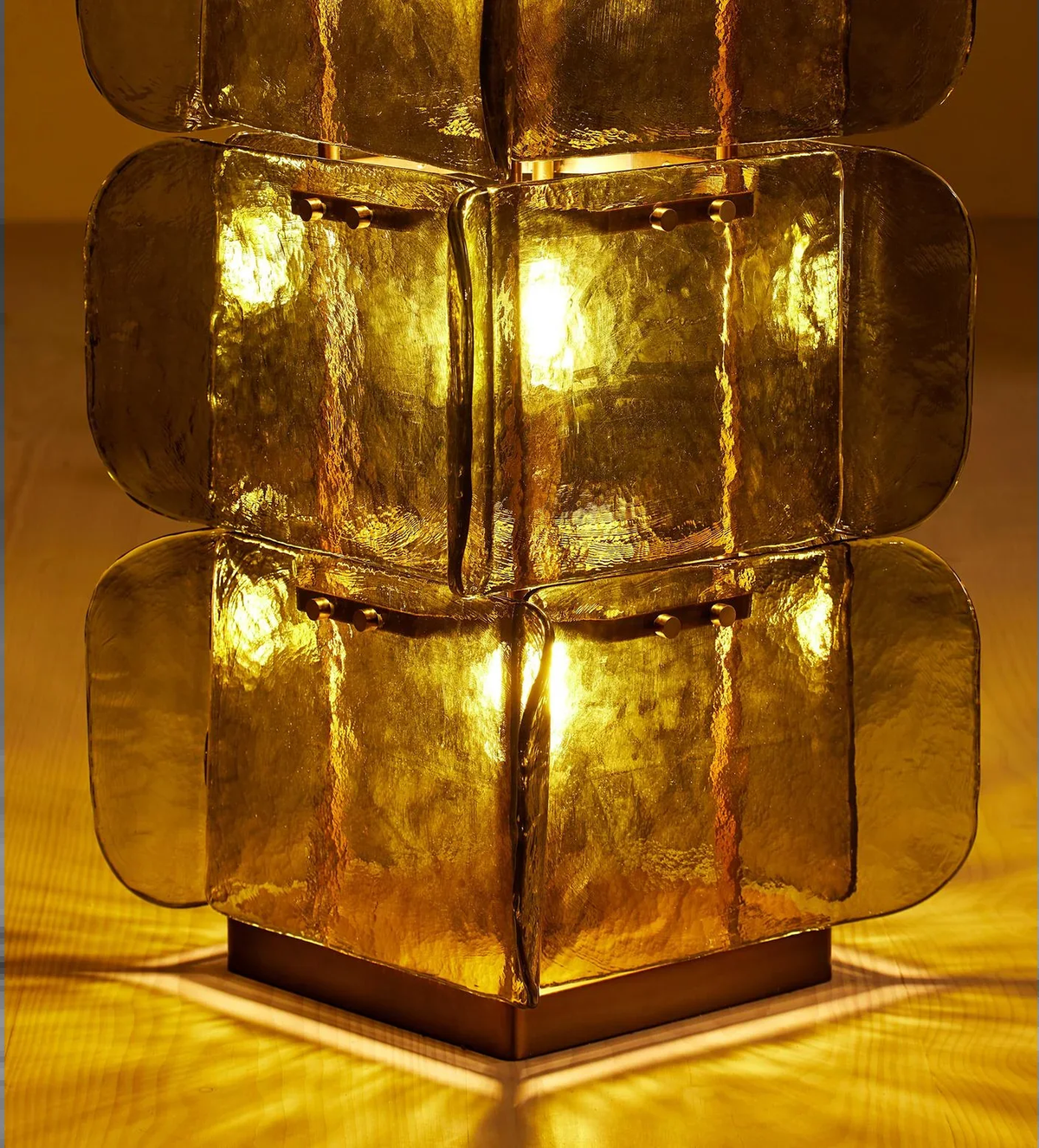 Close-up of glowing glass panels and square metal base