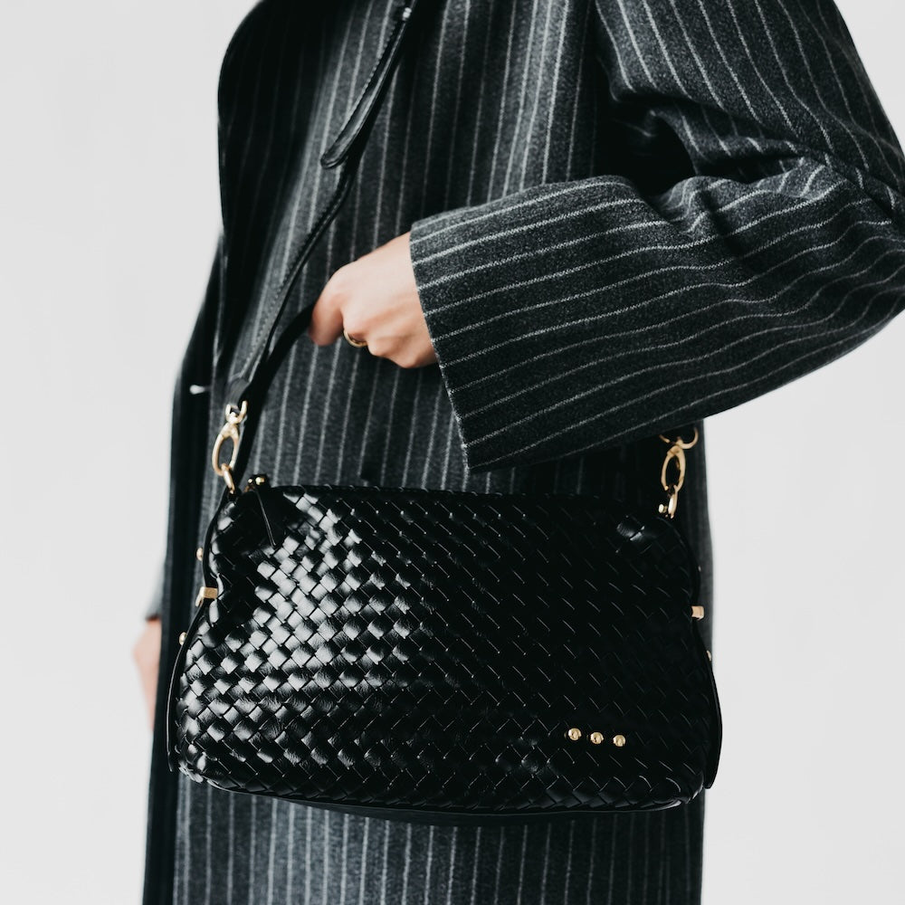 Woven hobo shoulder bag in black with top zip and gold studs on the front