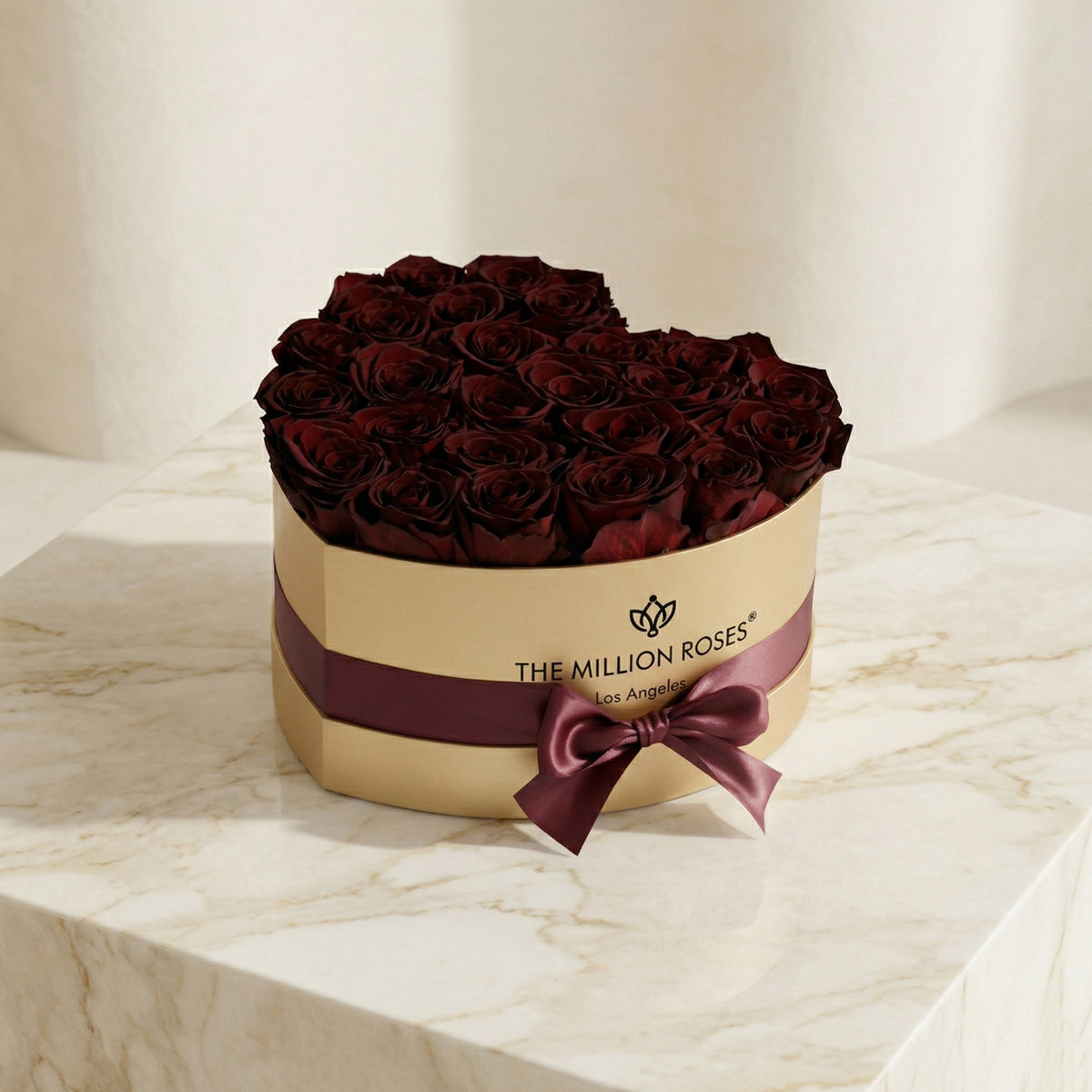 Gold gift box with burgundy roses, burgundy satin ribbon, and bow