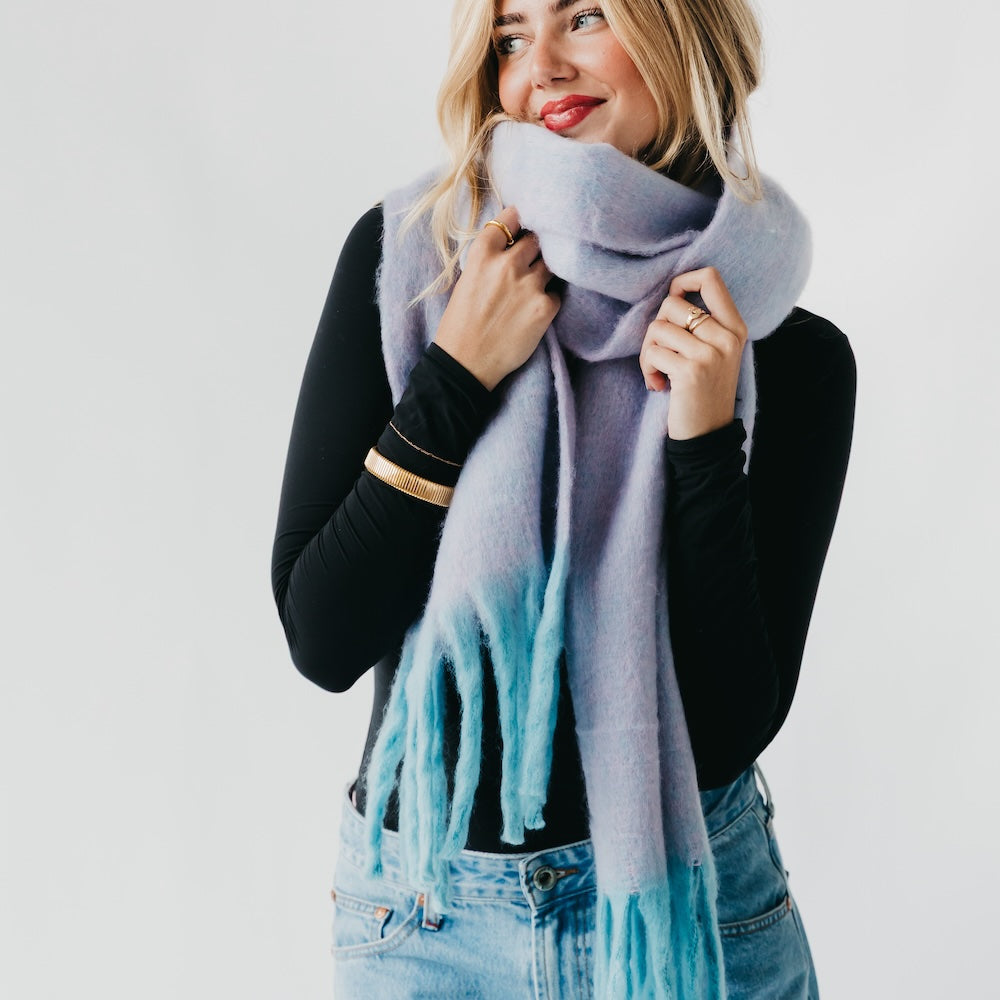 Lavender blanket scarf with long fringe, worn wrapped around the neck
