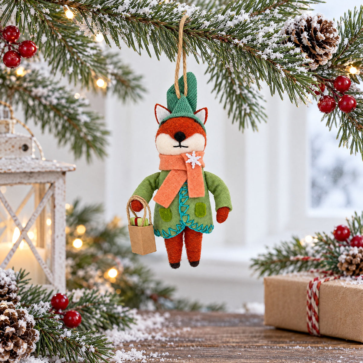 Felt fox Christmas ornament with teal knit hat, orange scarf, and gift bag
