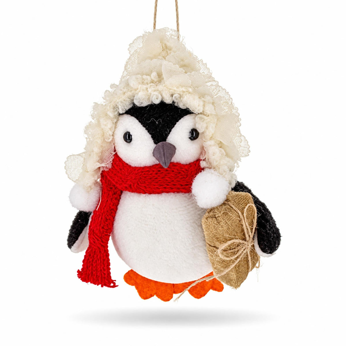 Felt penguin Christmas ornament holding burlap-wrapped gift, red scarf, cream hood