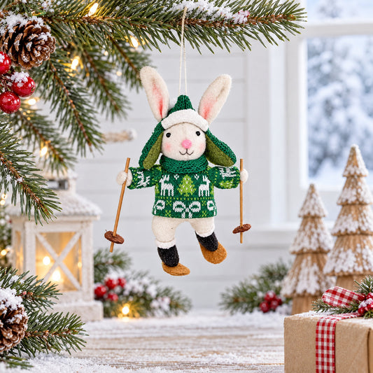 Hanging felt bunny skiing ornament wearing green patterned sweater and wooden skis