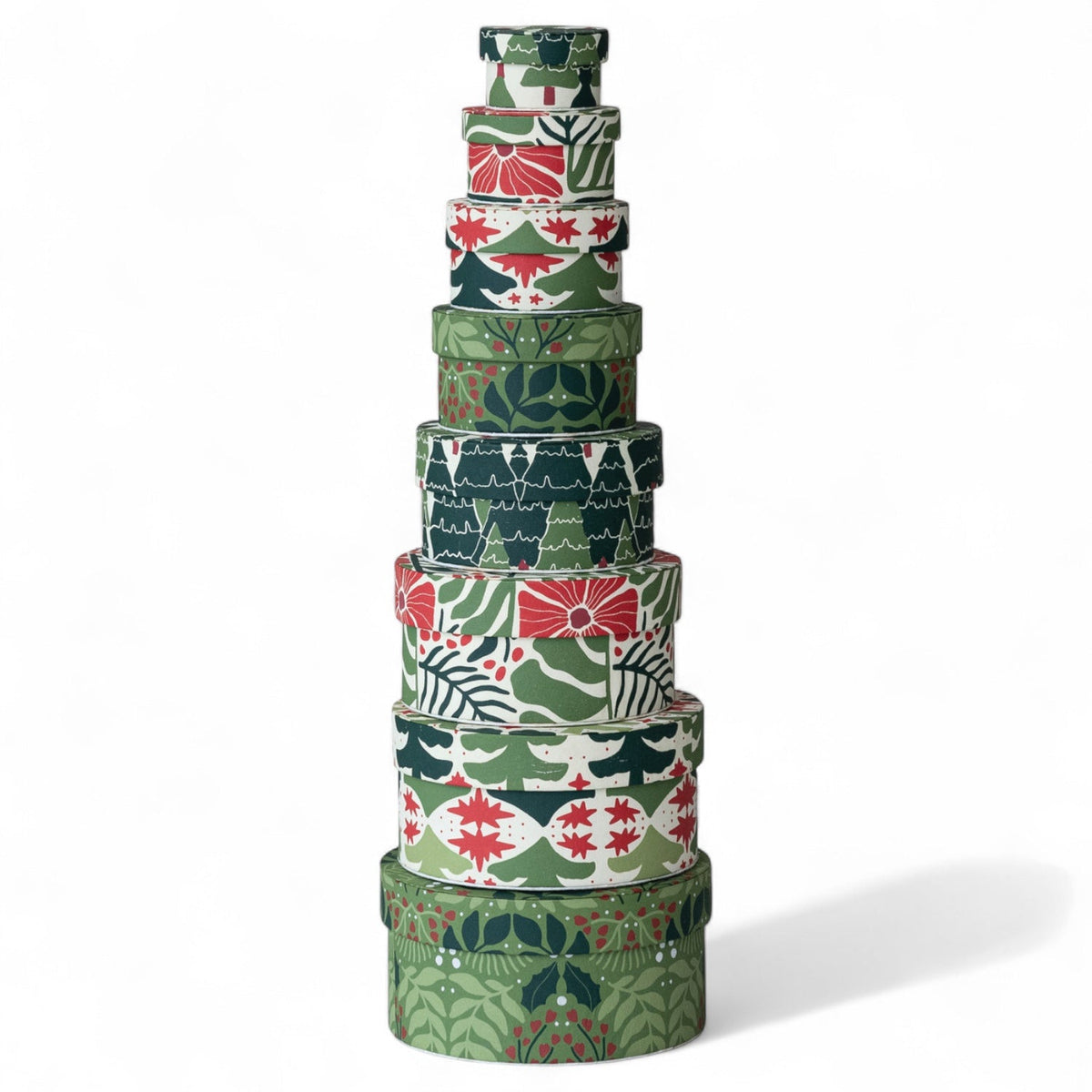 Stack of round green botanical nesting gift boxes, handmade recycled paper
