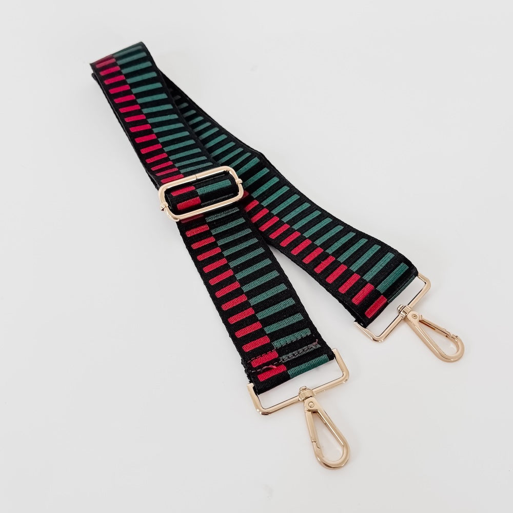 Set of striped bag straps in green, black, and red with gold metal buckles and clips