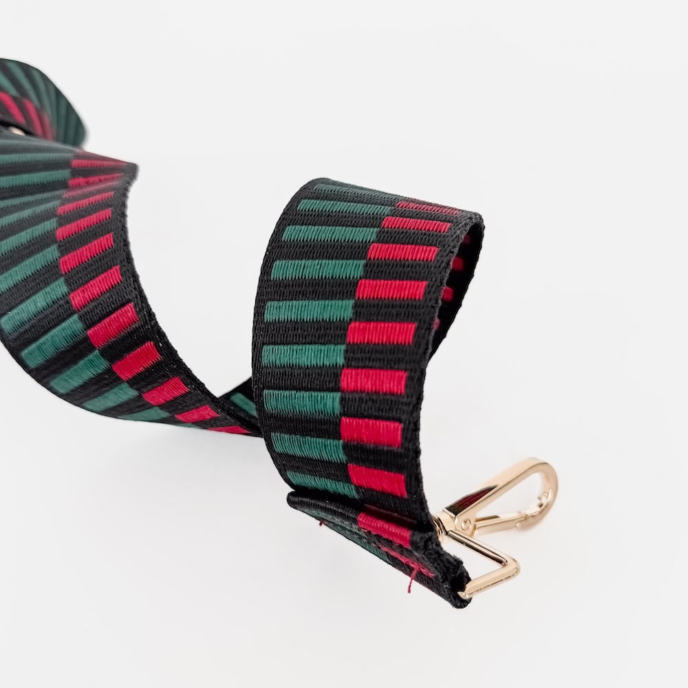Striped bag strap end with stitched edge and gold metal clip hardware