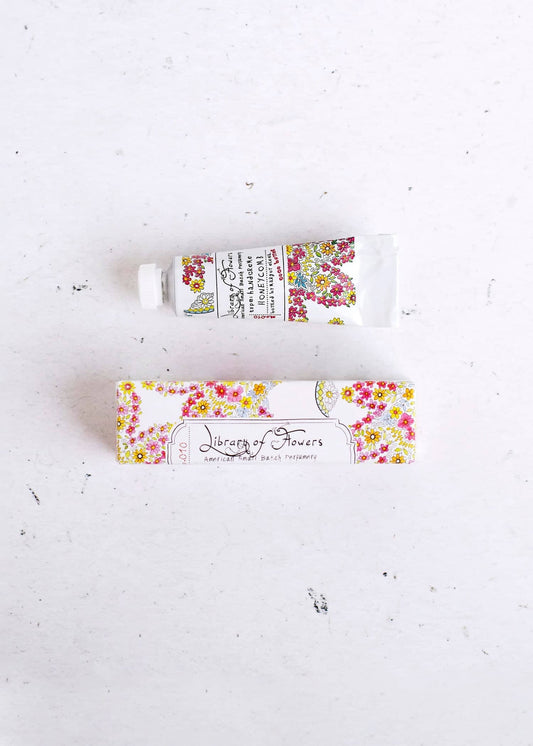 Small floral hand cream tube with matching floral sleeve label, white tube and colorful blossoms