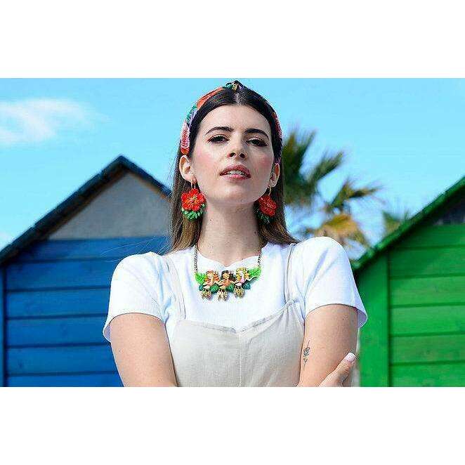 Hula girls necklace worn at the neckline with braided chain and three charm figures