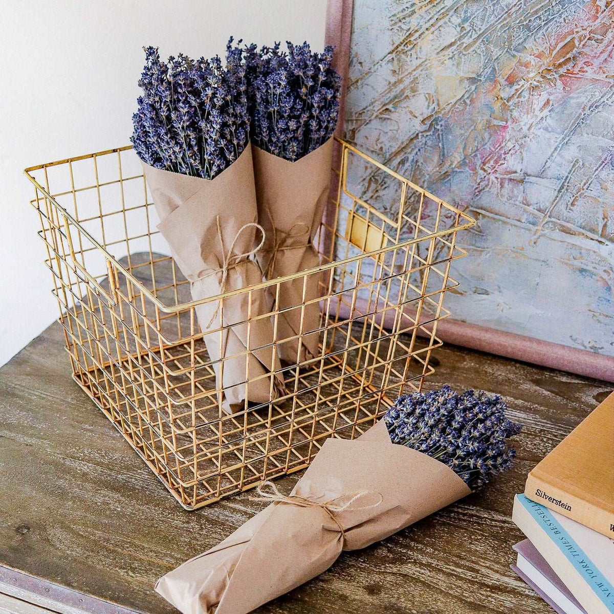 Dried lavender bundles in kraft paper wraps tied with twine, in wire basket