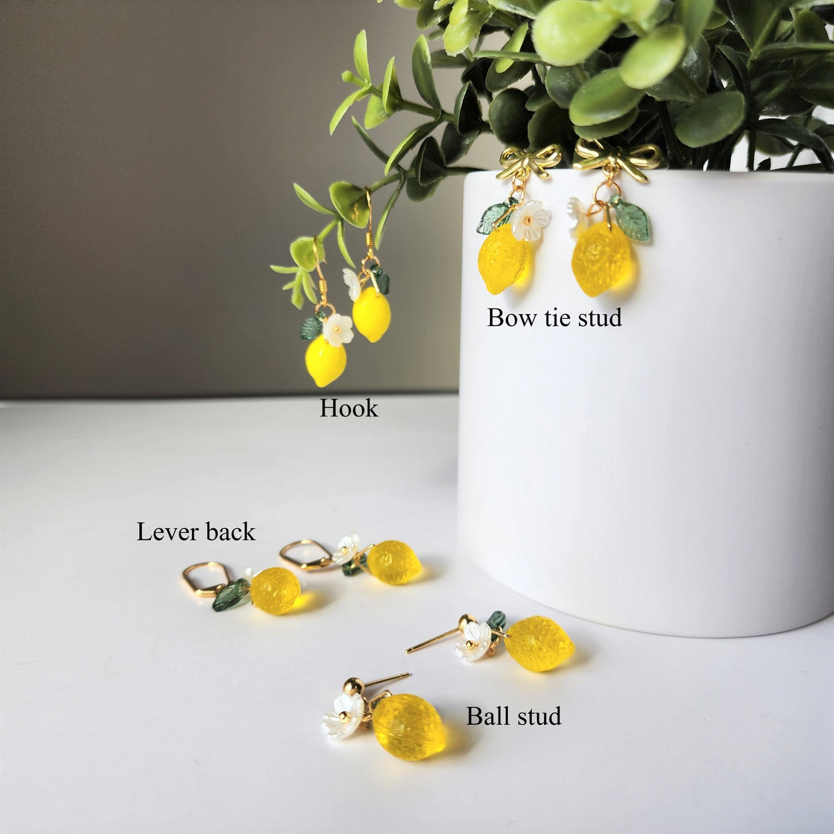 Gold lemon dangle earrings with flower and leaf charms; includes hook, lever-back, ball-stud styles