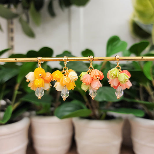 Gold-tone dangle tulip bouquet earrings with yellow, peach, pink, and green flower clusters