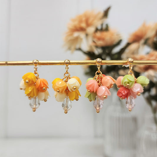 Gold-tone tulip bouquet dangle earrings with yellow, orange, pink, and green blooms