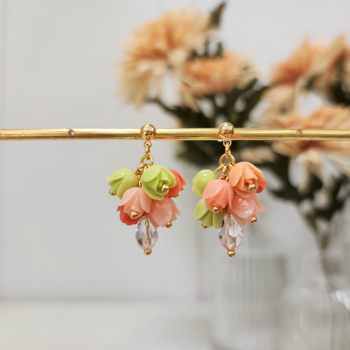 Gold-tone tulip bouquet dangle earrings with green and pink flower clusters
