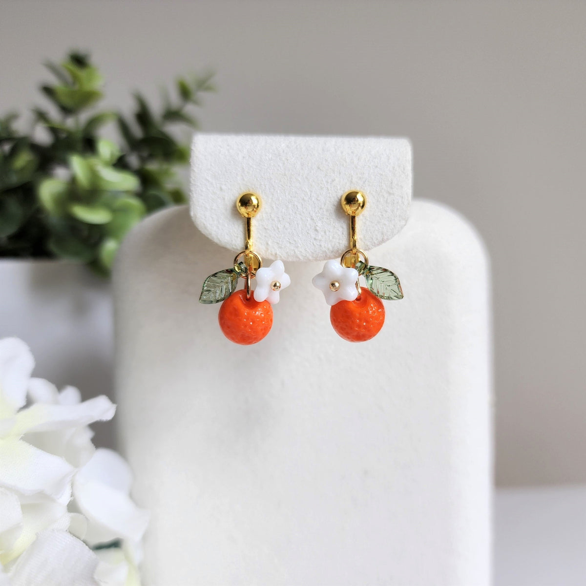 Orange fruit earrings with white flower and green leaf, gold stud backs