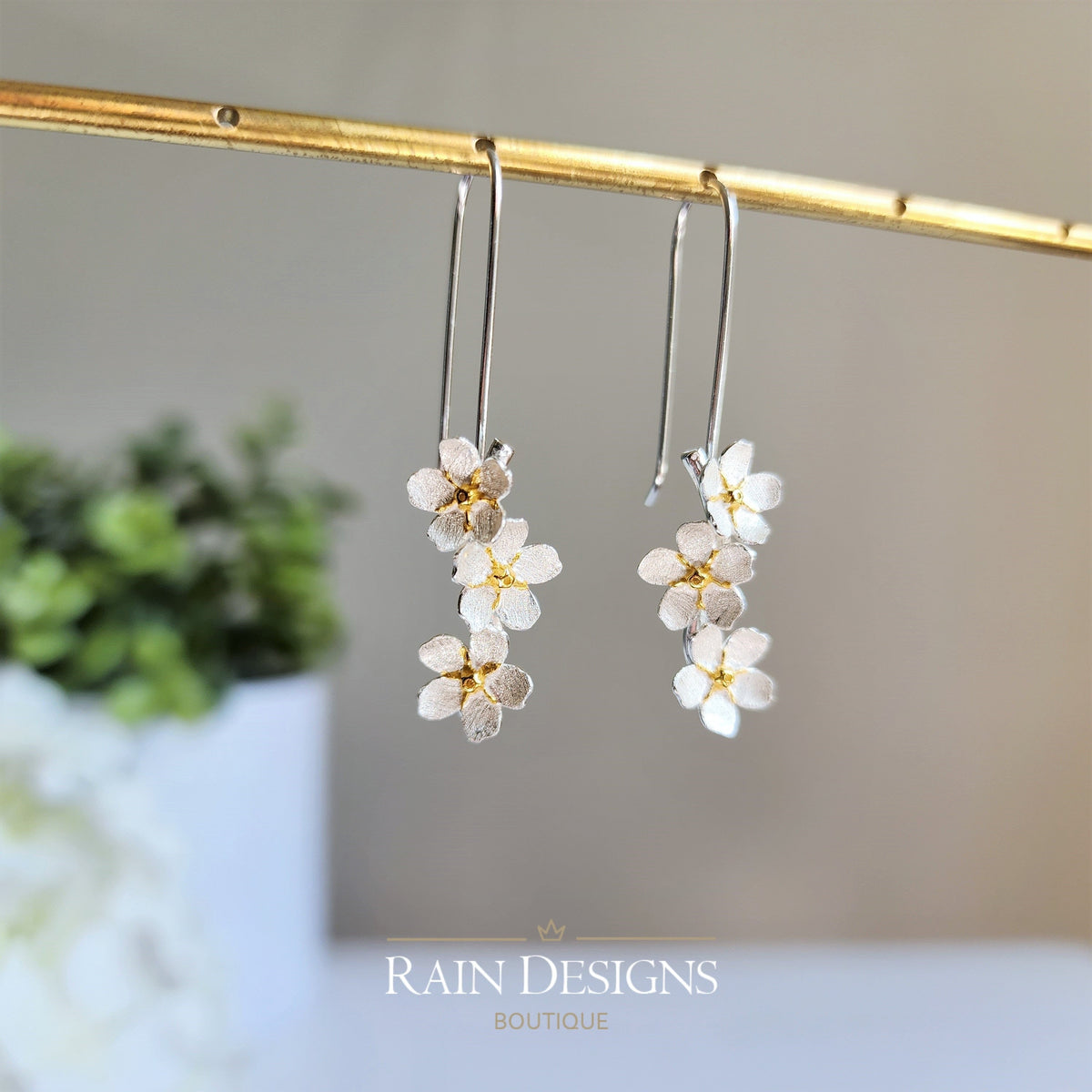 Silver hook earrings with layered forget-me-not style flower clusters