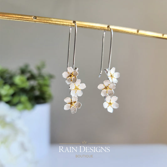 Silver hook earrings with layered forget-me-not style flower clusters