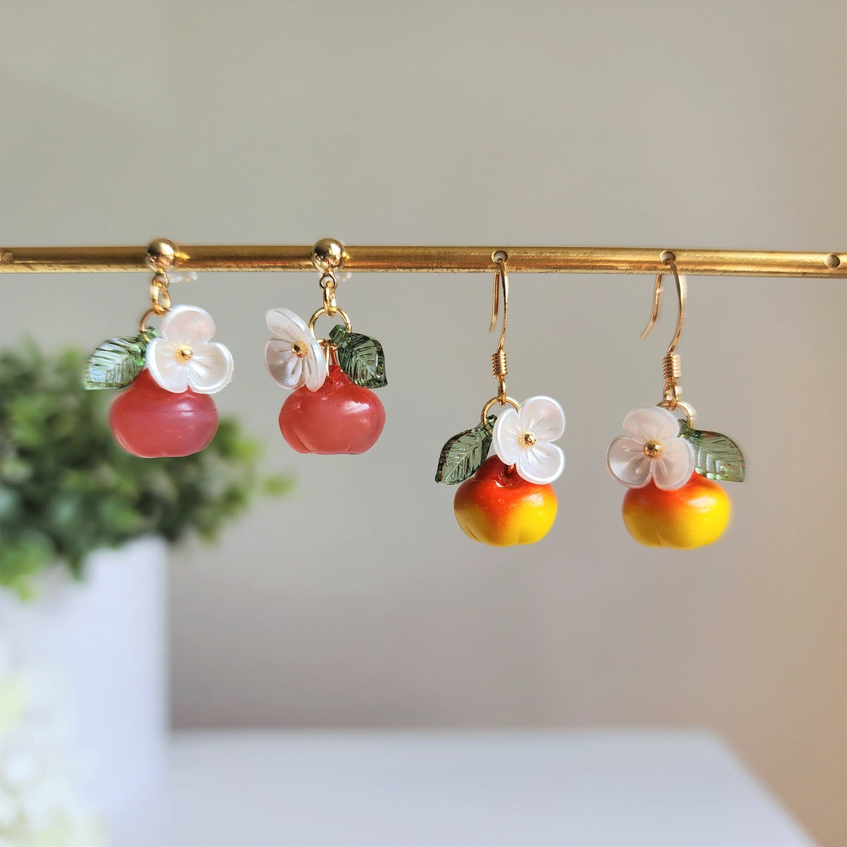 Gold apple earrings dangle bar: red to orange-yellow fruit charms with white flowers