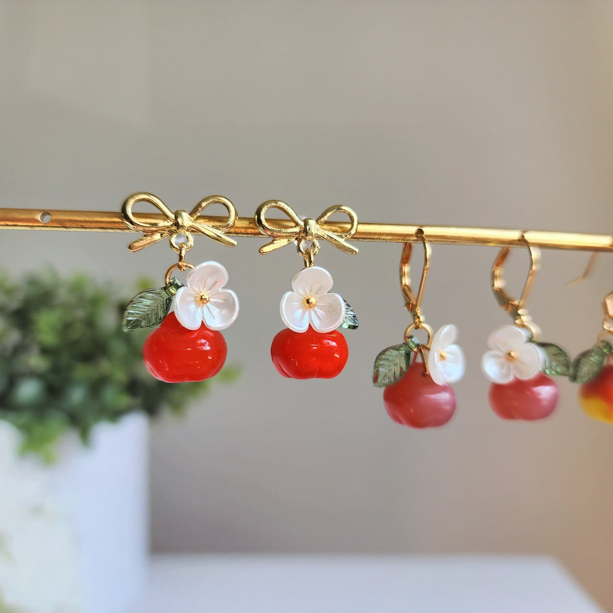 Gold apple earrings dangle bar: red fruit charms with white flower tops and green leaves