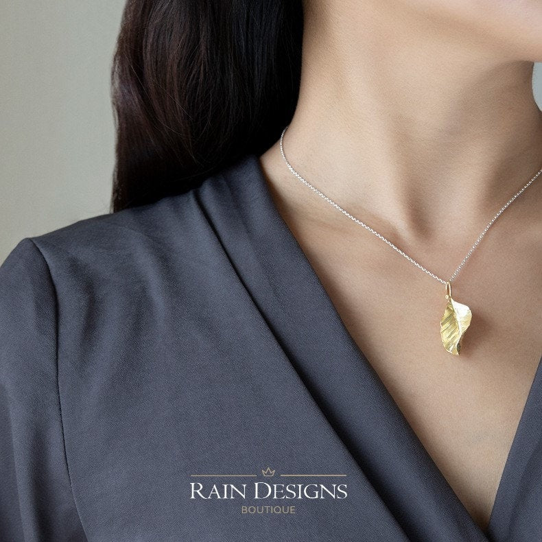 Gold leaf pendant on silver chain necklace with teardrop loop clasp