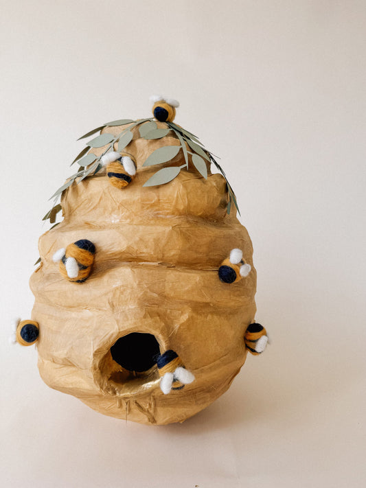 Honey beehive pinata decoration with leaf-like wings and striped bee details