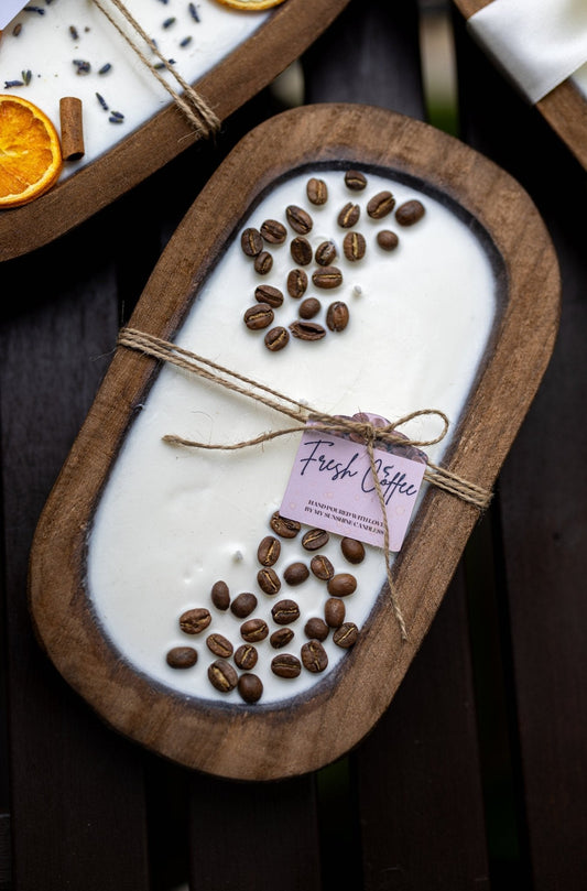 Oval wooden candle dish with coffee-scented wax, coffee beans, and twine-wrapped tag